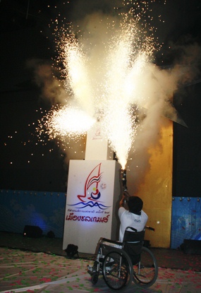 The Games flame lights up the stadium.